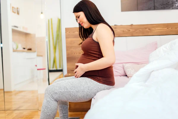 Pregnant woman having belly ache