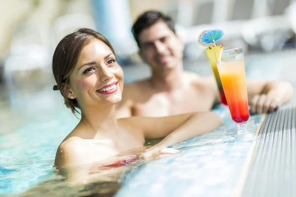 People drinking cocktails by the swimming pool