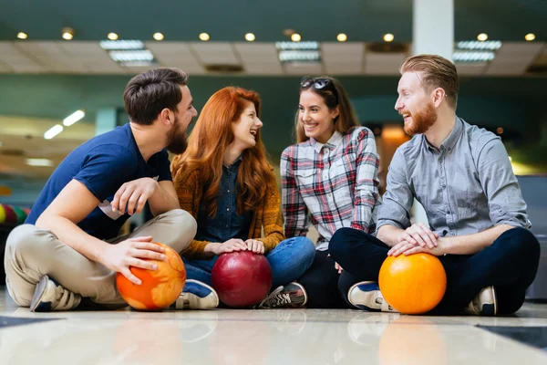 Friends enjoying bowling at club