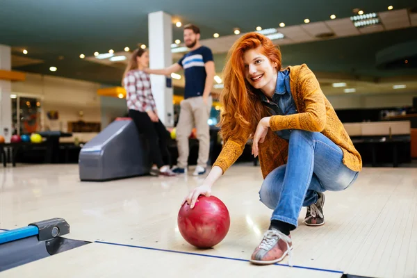 Friends enjoying competitive bowling