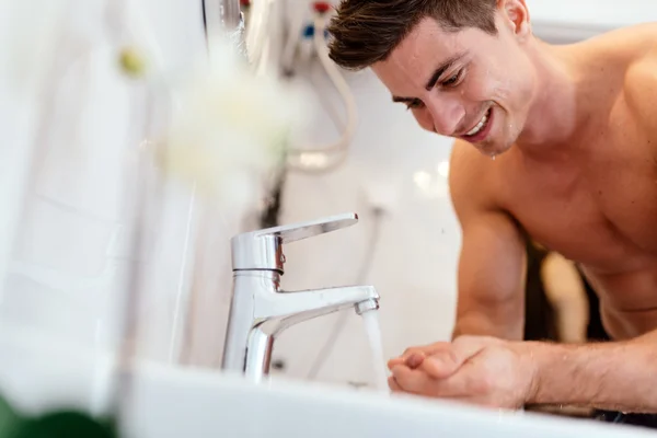 Man washing face in morning