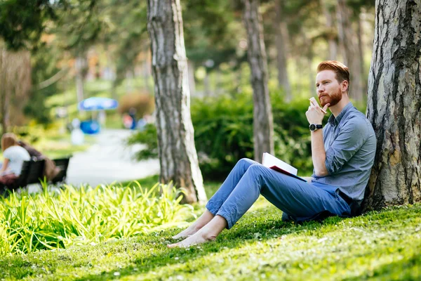 College student studying in park
