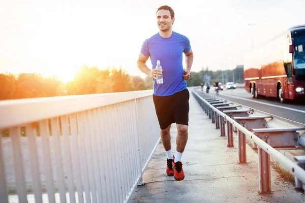 Sportsman running over bridge