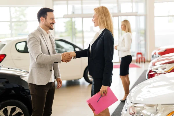 Professional salesperson in car dealership