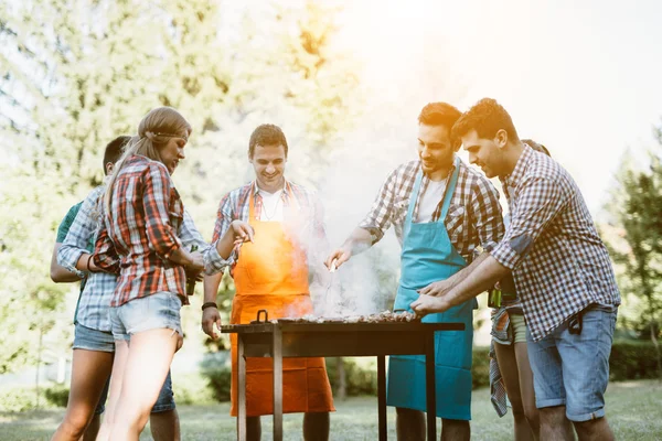 Young people enjoying barbecuing