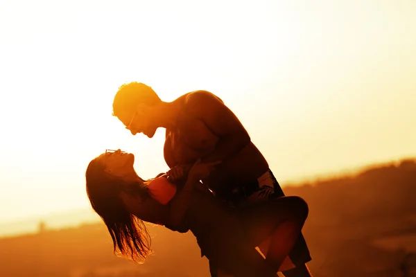 Romantic dance at sunset by couple