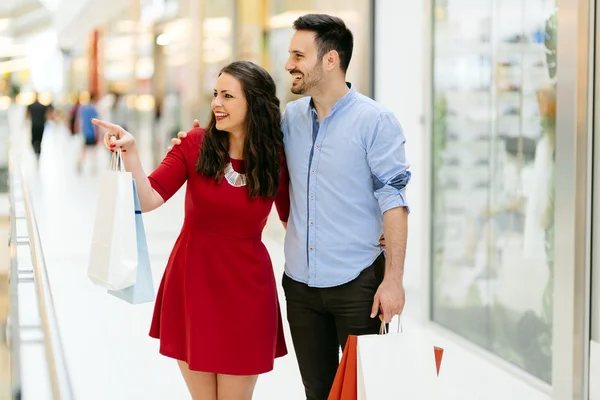 Happy shopper couple buying clothes