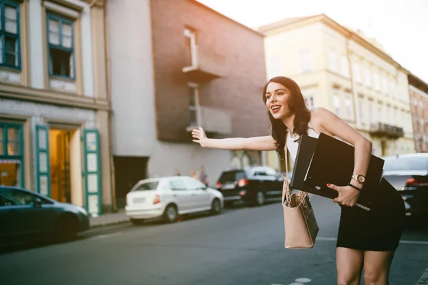 Businesswoman catching a taxi