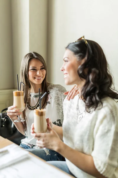 Girls drinking coffee and smiling