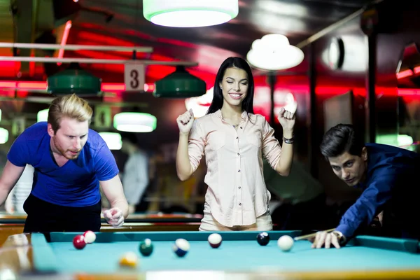 Young people playing billiard