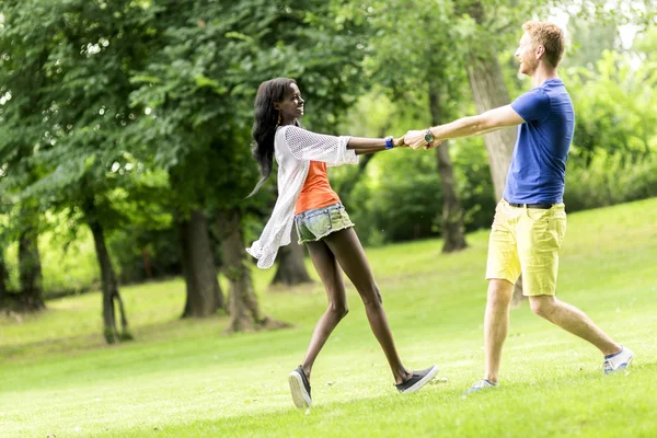 Beautiful couple dancing outdoors in a park