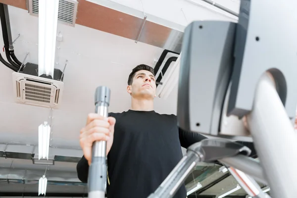 Man working out on an elliptical trainer
