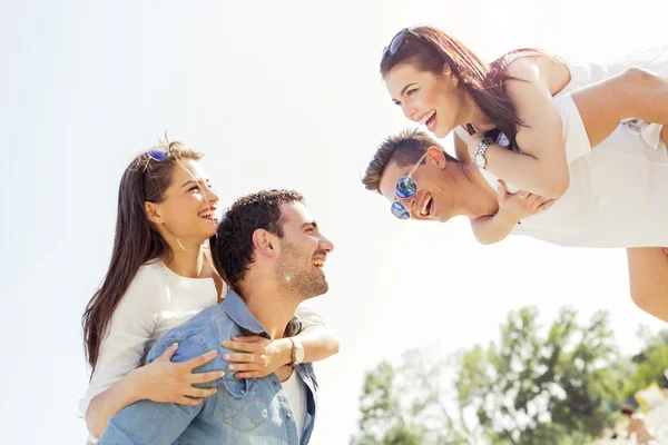 Group of happy people carrying women