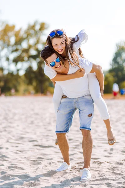 Man carrying his girlfriend piggyback