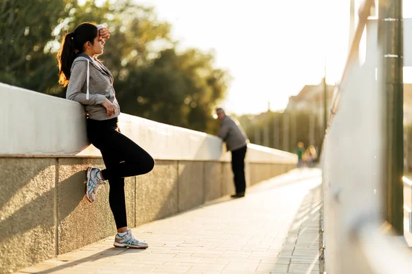 Beautiful woman resting after jogging