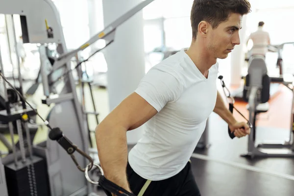 Handsome man training in clean modern gym