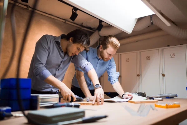 Two creative designers working in workshop