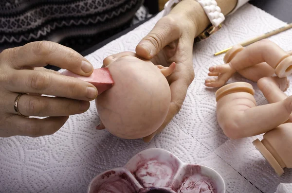 Hand painted reborn dolls. Application of lacquer on head.