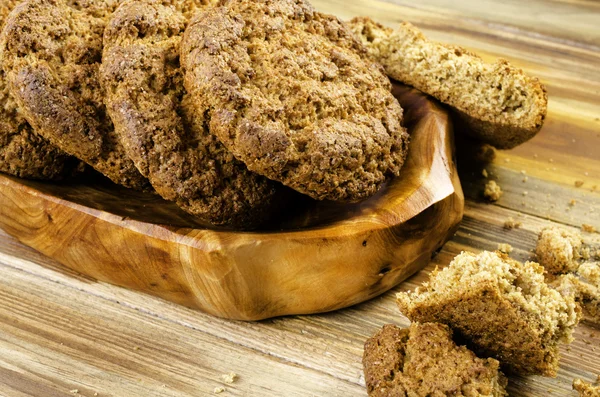 Oatmeal cookies crumbs in a wooden platter.