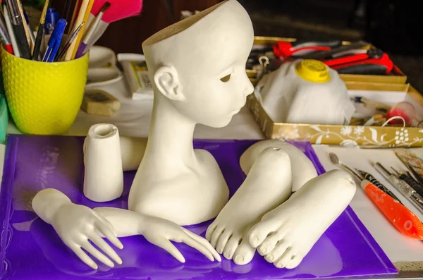 The process of making dolls.