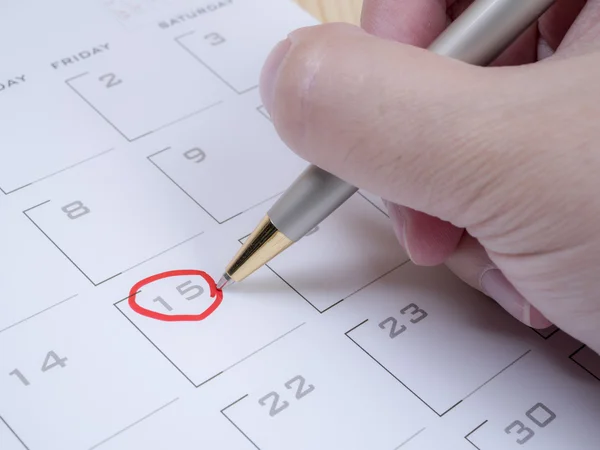 Woman hand circle date on calendar 1