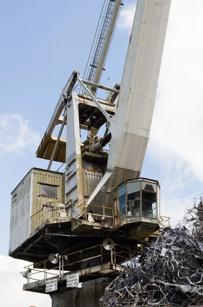 Large industrial crane and a heap of metal junk