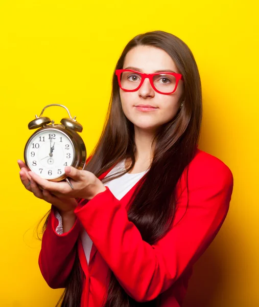 Portrait of young woman with clock