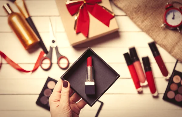 Hand  wrapping cosmetics in christmas gifts