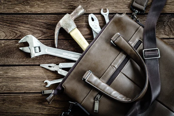 Tools in leather bag - labor day and business fight background c