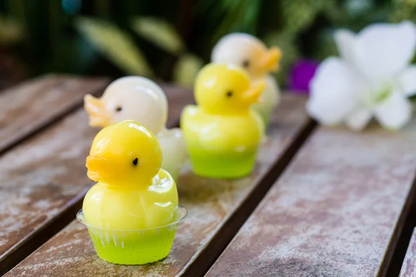 Cute duck jelly dessert with flower background