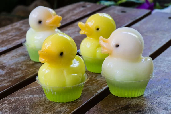 Cute duck jelly dessert with flower background