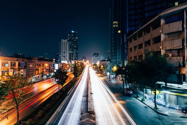 The traffic light trails on the street of Bangkok