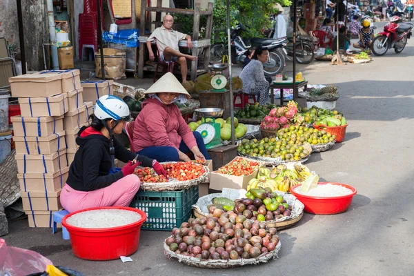 Vietnamese women are selling fruits at the wet market in Nha Tra