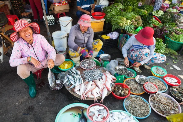 Women are selling seafood at the wet market