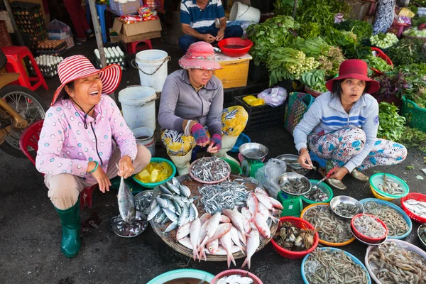 Women are selling seafood at the wet market