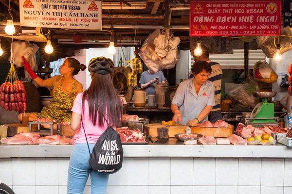 Women are selling meat at the wet market