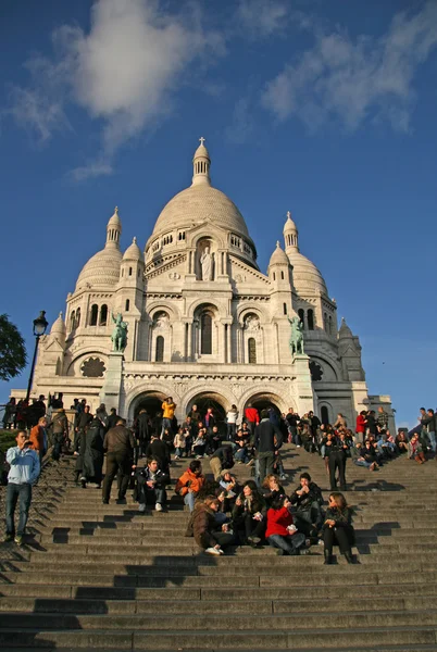 PARIS, FRANCE - NOVEMBER 27, 2009: Tourists near the Basilica of the Sacred Heart of Paris (Sacre-Coeur) that is a Roman Catholic church. Located at the Montmartre