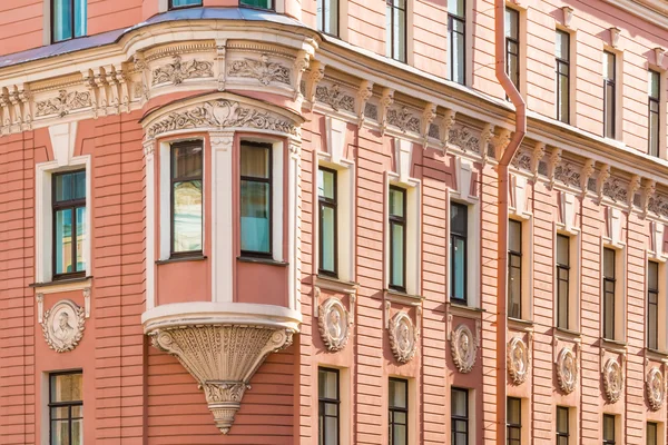 Windows in a row and bay window on facade of apartment building