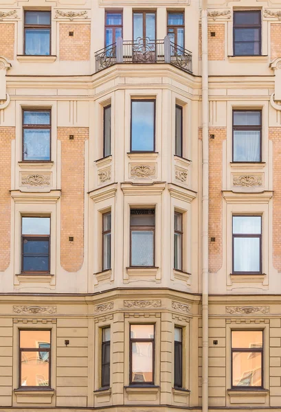 Windows in a row and bay window on facade of apartment building