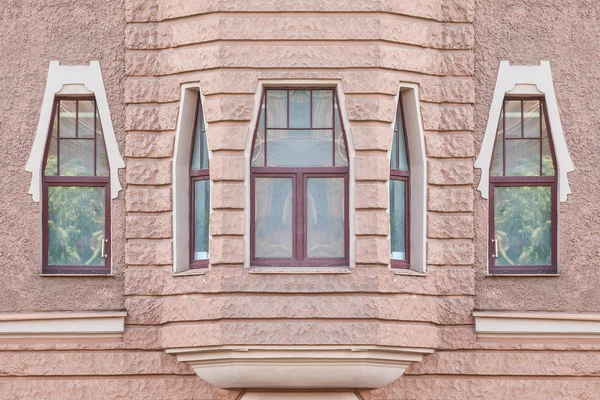 Windows in a row and bay window on facade of apartment building