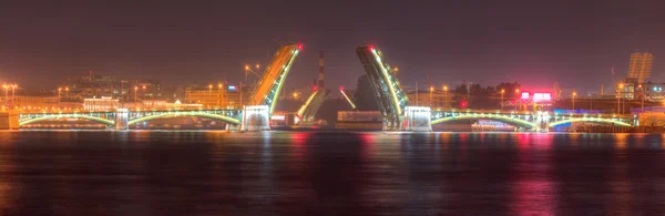 Night view of open Birzhevoy Bridge and Tuchkov Bridge