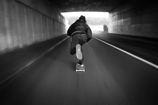 Skateboarder pushing on the streets
