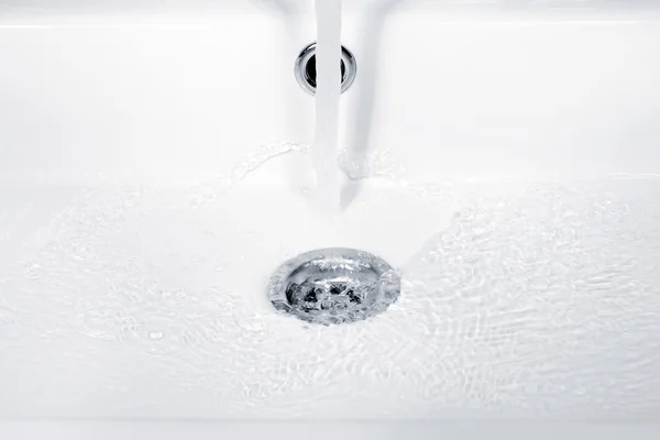 Water flowing, ripples and bubbles in sink