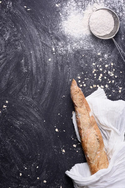 Rural kitchen or bakery background on black chalk board with space for text. Top view, vertical.