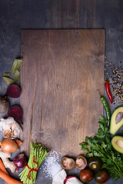 Healthy food background on wooden board. Vegetable menu. Top view, copy space.