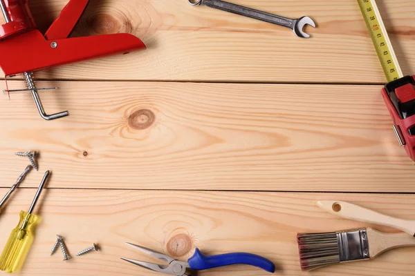 Carpentry, construction hardware tools on wooden planks. Top view copy space.