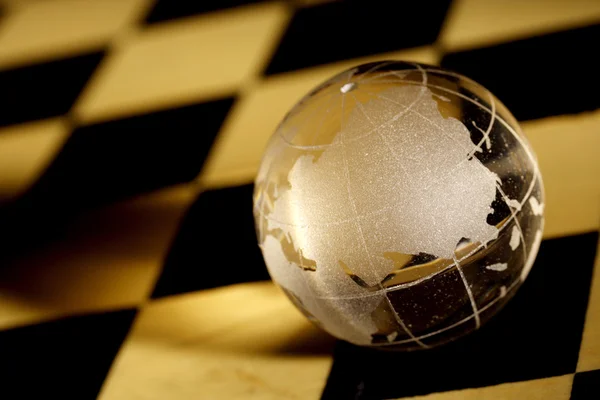 Glass globe on a chessboard