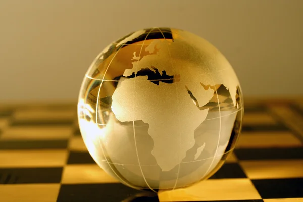 Glass globe on a chessboard