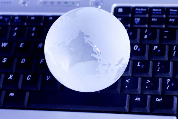 Closeup of Glass globe on computer keyboard