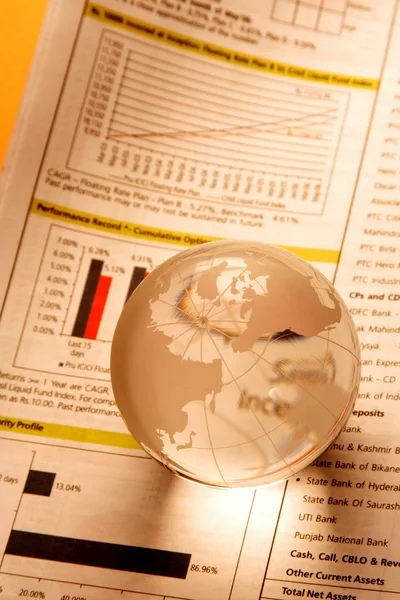 Glass globe on business document